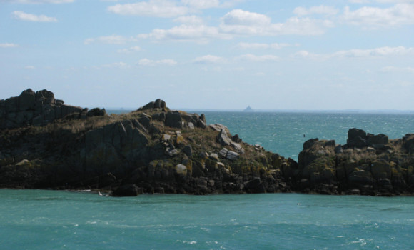 A distant view of Le Mont Saint Michel from Le Point de Grouin, Brittany. GLK.