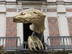 Dragon emerges from a window at the House of Magic, Blois.