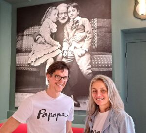 Damien and Caroline Nobile beside the blown-up photograph of Papapa and the grandkids. Photo GLK.