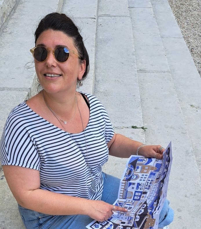 Graphic artist and illustrator Mathilde Arnaud looking up at the chateau from the steps at the entrance chateau de La Roche-Guyon. Photo © GLK.